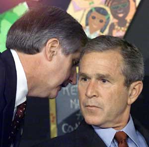 Andrew Card whispers into Bush's ear